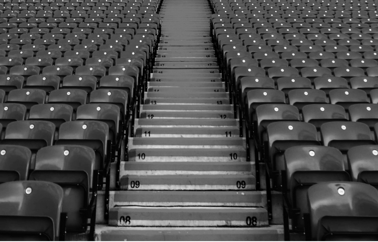 A wide photograph showing empty football stadium seats