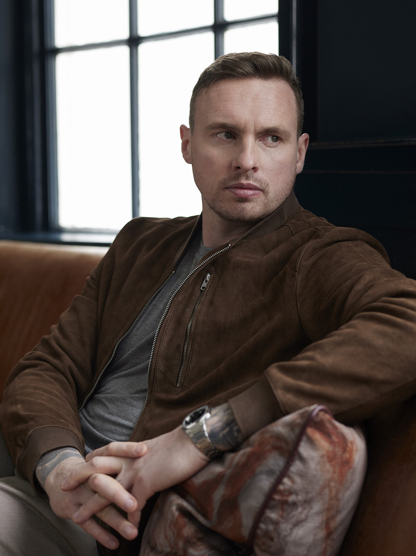 David Stockdale sitting on a leather sofa