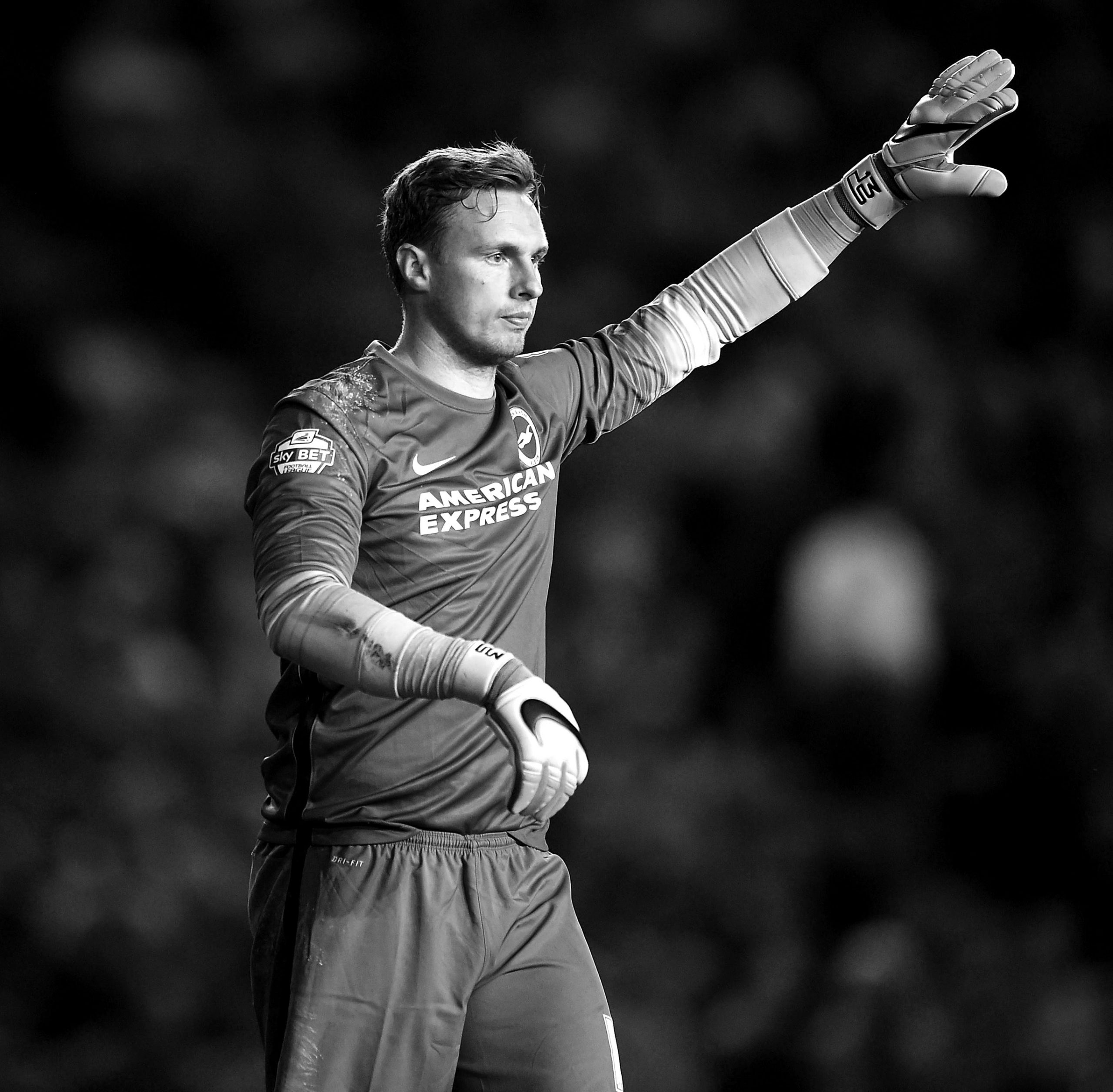 David Stockdale on the pitch, holding his hand up in the air asking for the ball